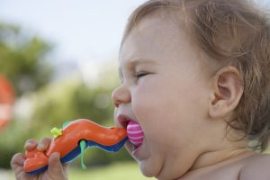 baby eating plastic toy - dangerous toys
